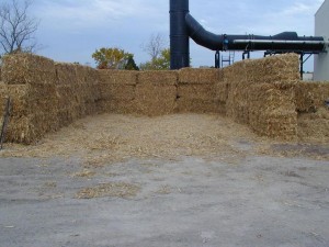 Bales of corn stover to be shredded for use in test burn